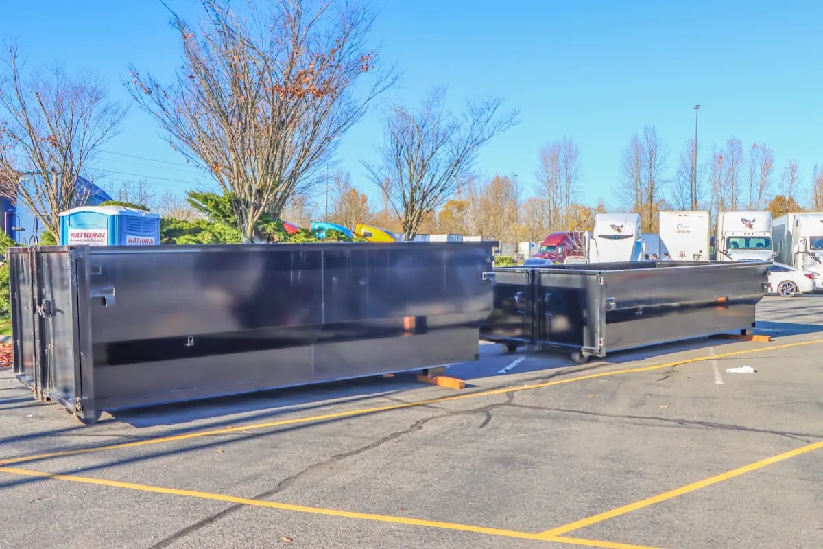 Professional dumpster rental service with roll-off container on residential driveway in Seven Hills